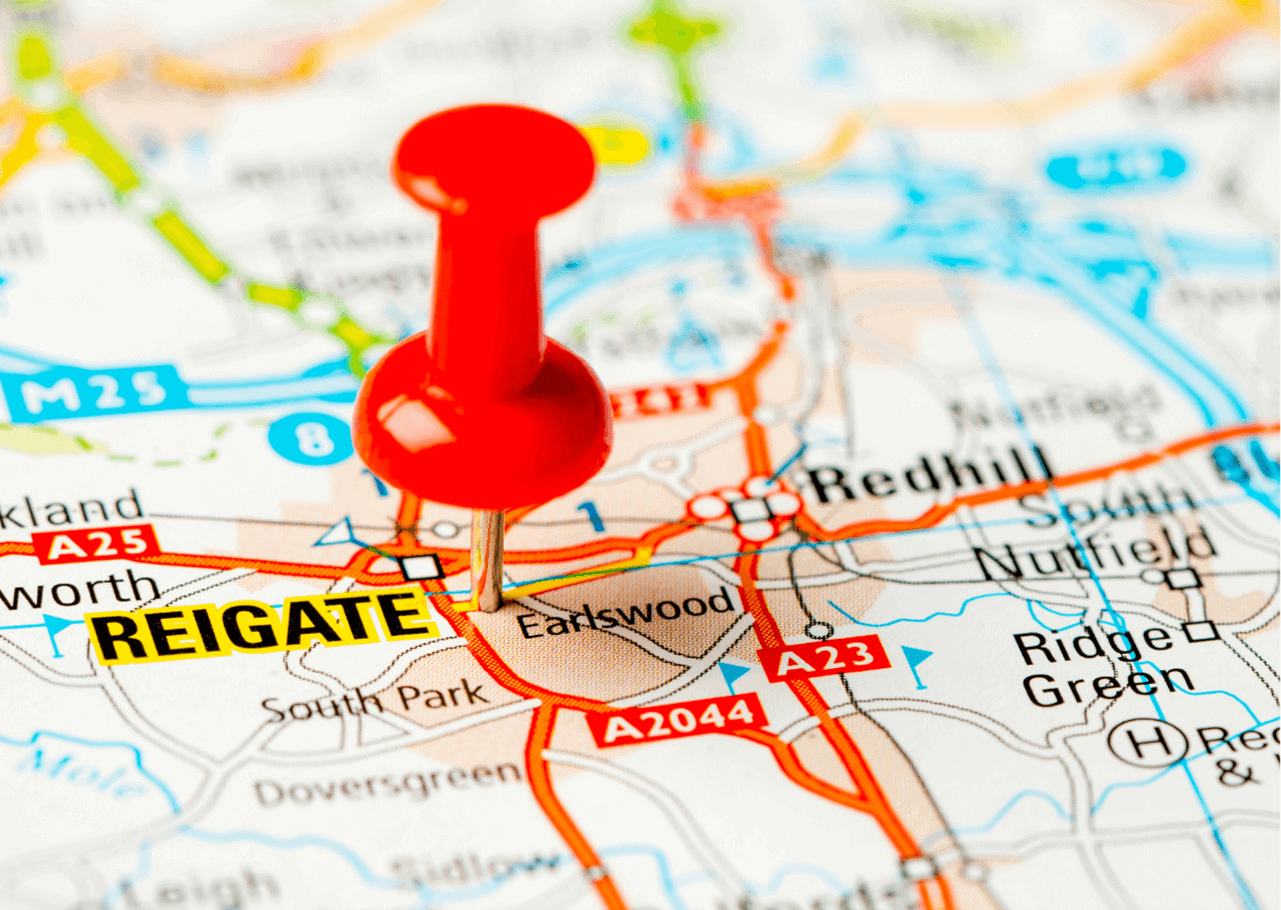 Close-up of a map with a red pushpin marking the location of Reigate. Surrounding areas, including Redhill and Earlswood, are visible. Roads such as A23 and A2044, landmarks like South Park and Nuffield, as well as local self storage options are also present on the map.